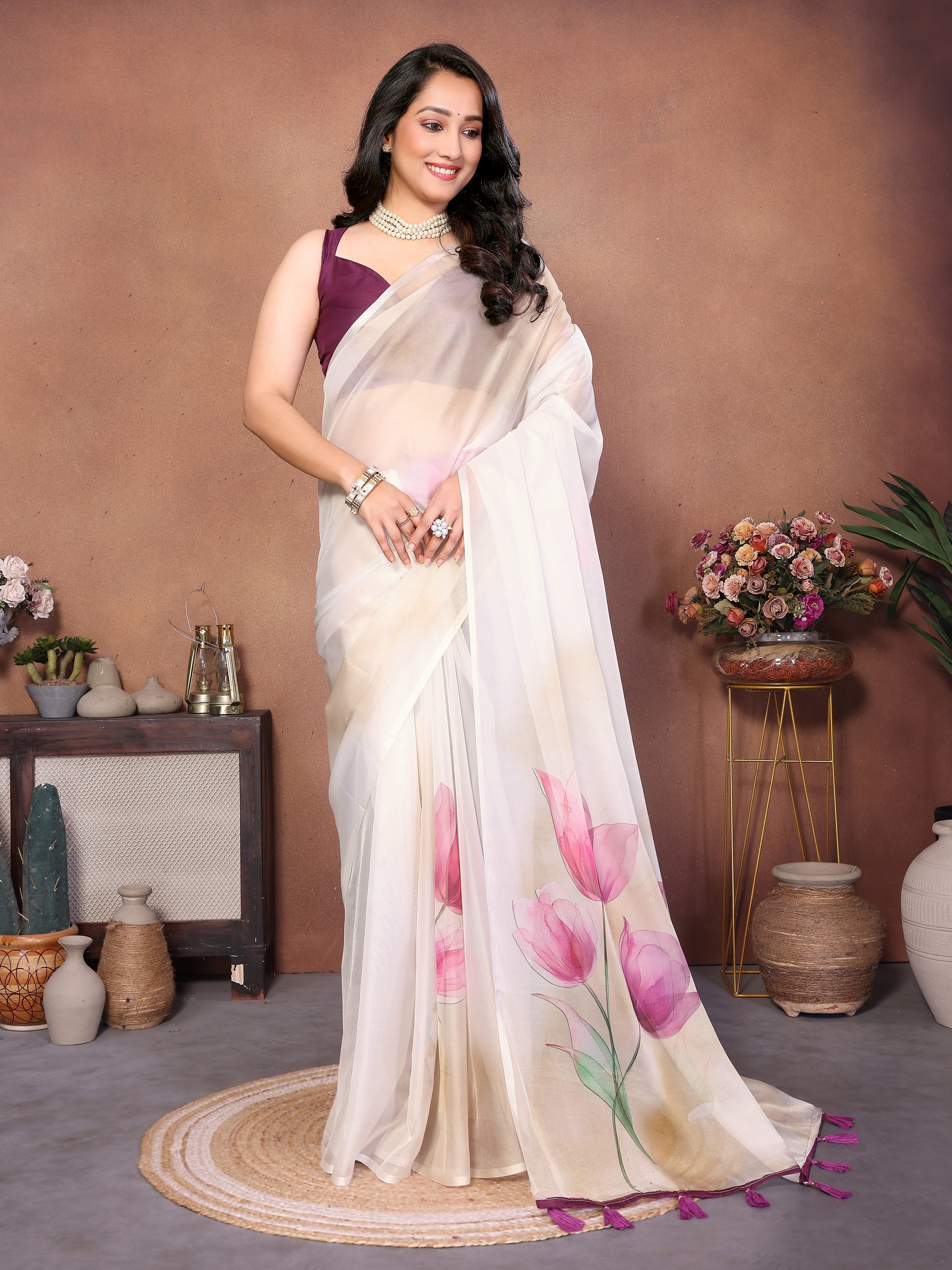Off-white tulip floral print saree with plum border, tassel pallu and ruched sleeveless blouse