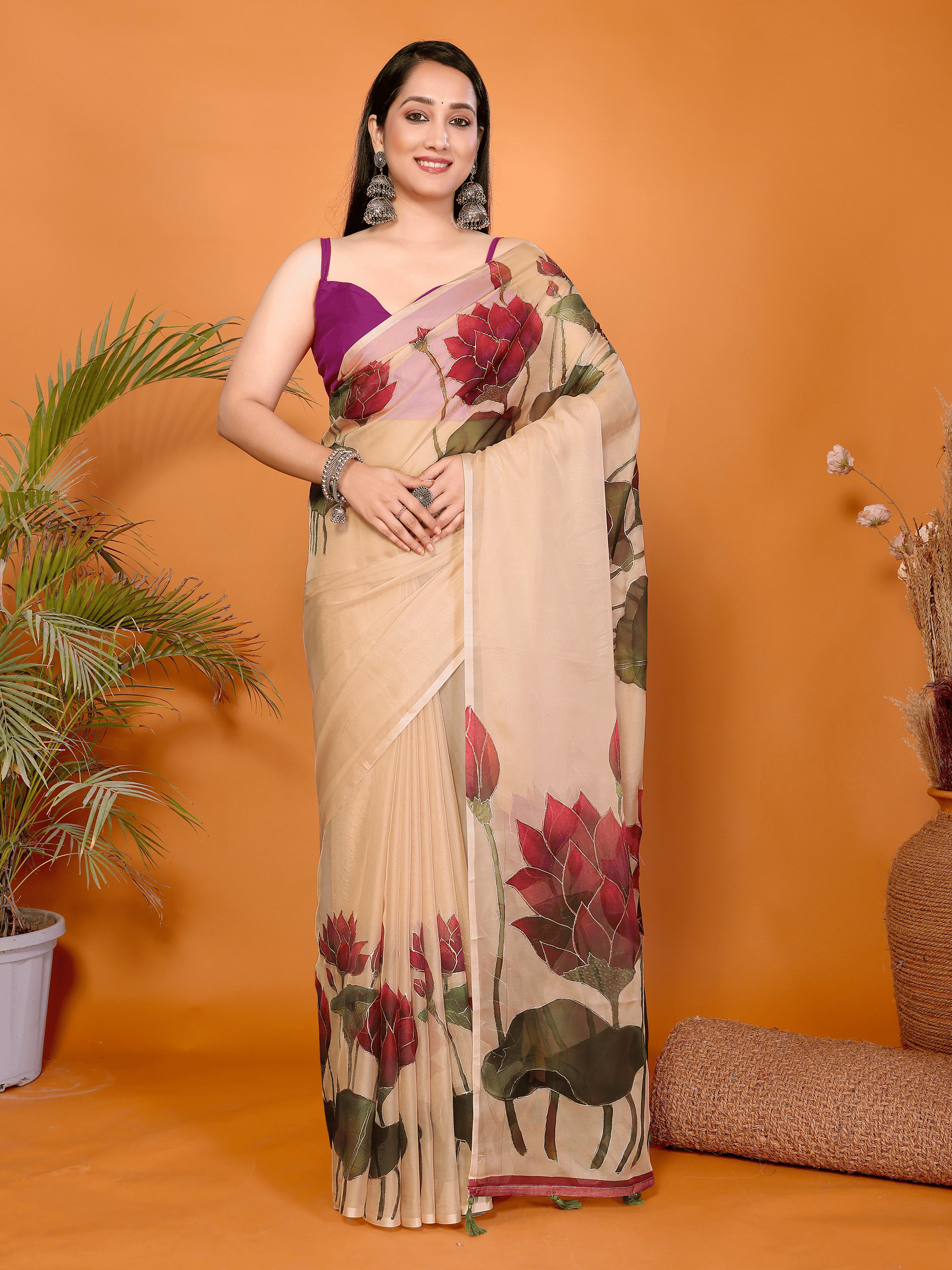 Peach lotus floral print saree with sheer fabric and green tassel pallu