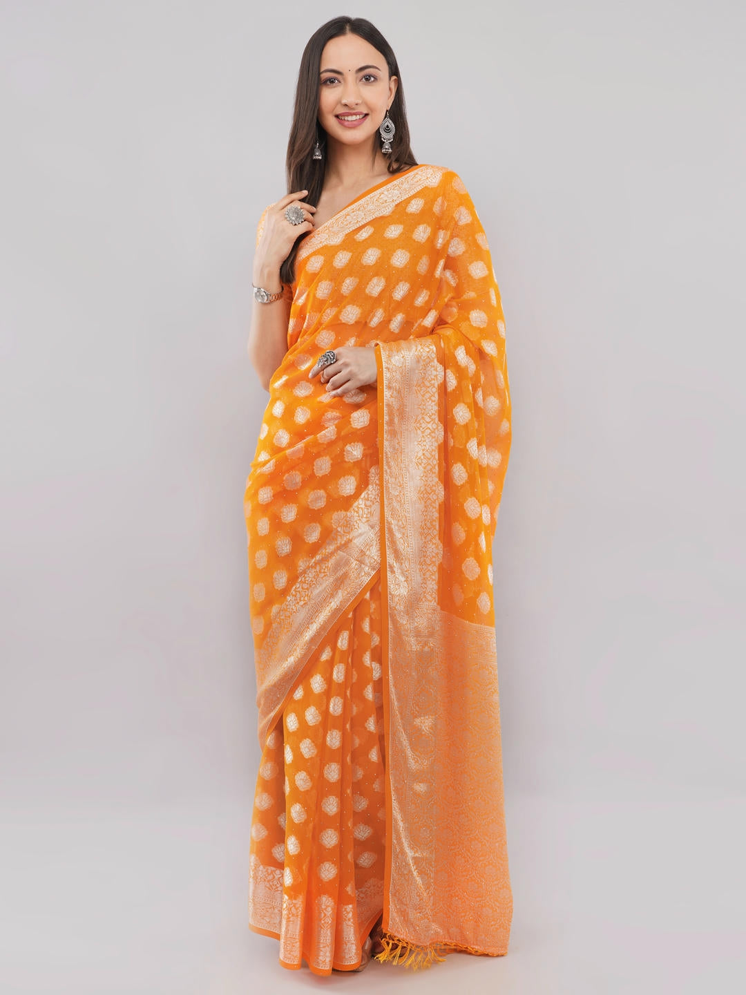 Beautiful woman styled in a classic bright orange and white geometric printed georgette saree featuring an abstract design and a matching unstitched blouse by Samantha.