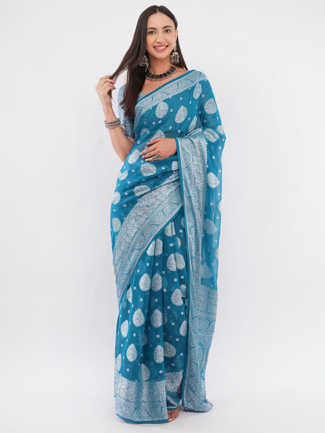 Beautiful woman styled in a classic rama green and white geometric printed georgette saree featuring an abstract design and a matching unstitched blouse by Samantha.