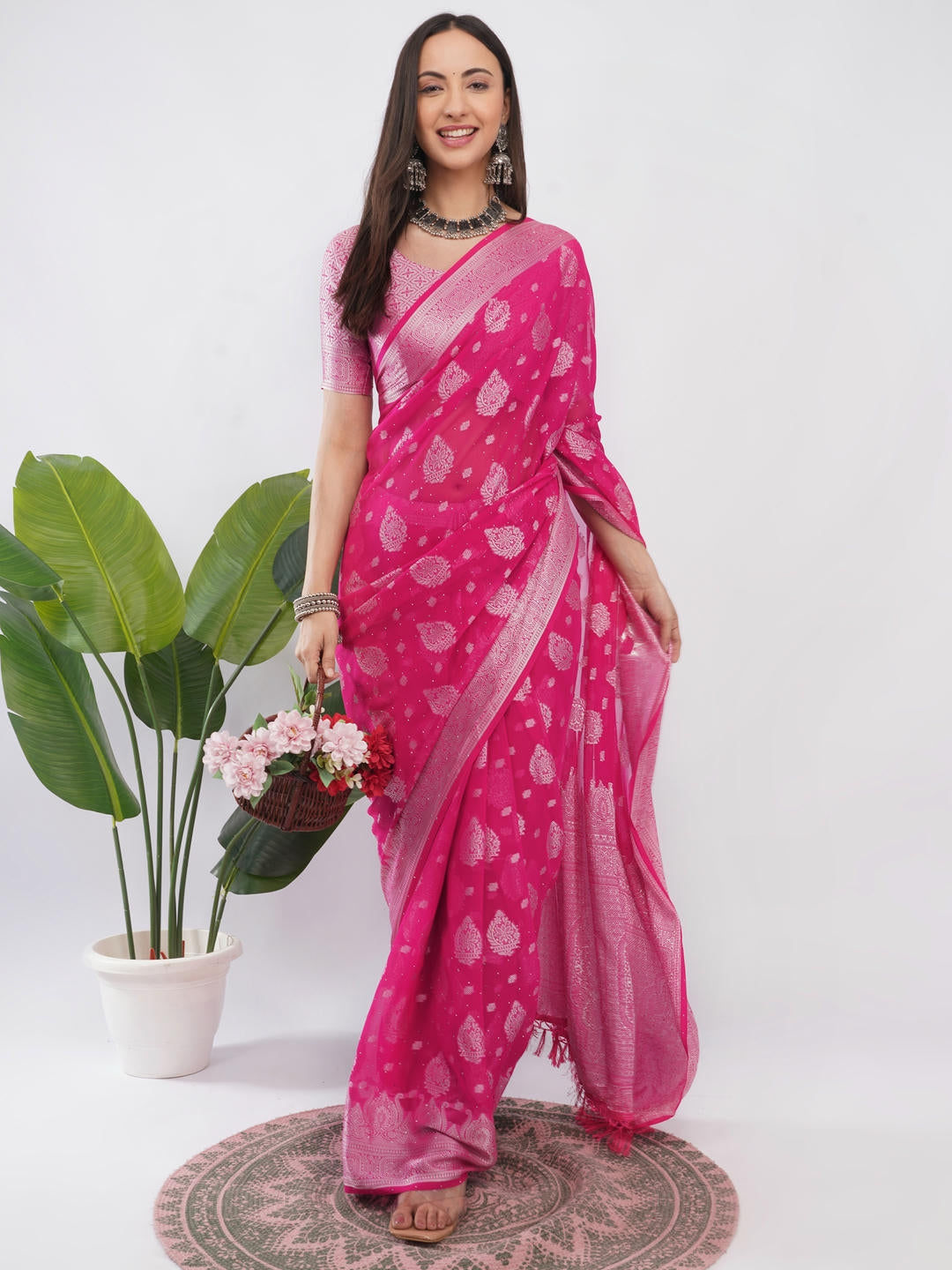 Beautiful woman styled in a classic red and pink geometric printed georgette saree featuring an abstract design and a matching unstitched blouse by Samantha.