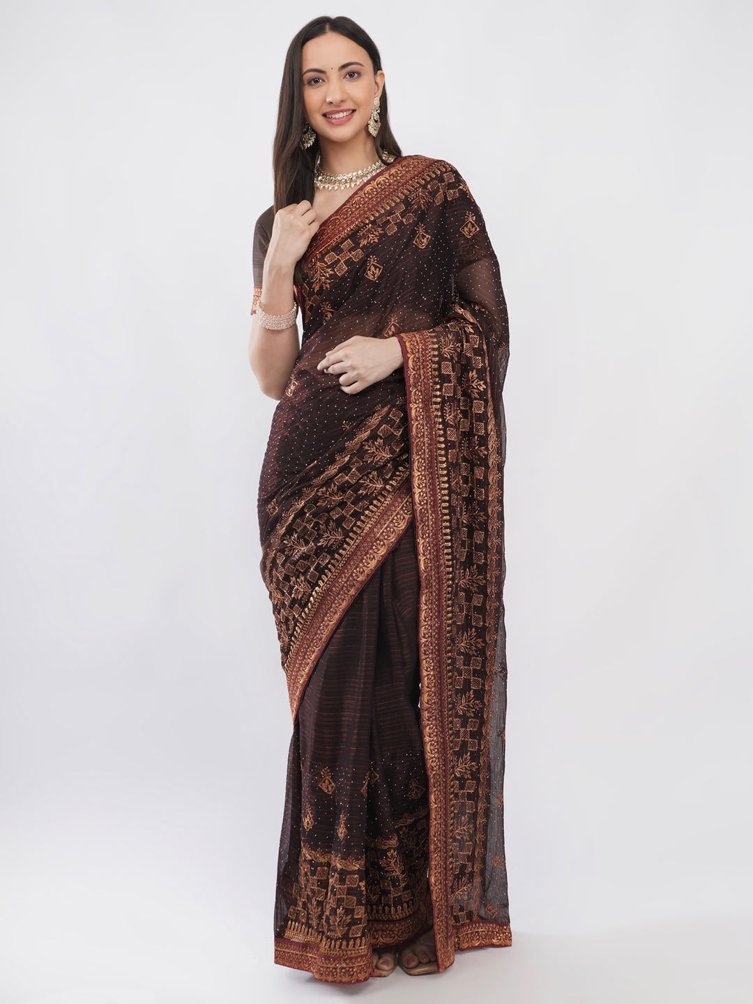 Beautiful woman styled in a classic metallic brown tissue silk shimmer saree featuring a contrast red zari border and a matching unstitched red blouse by Samantha.