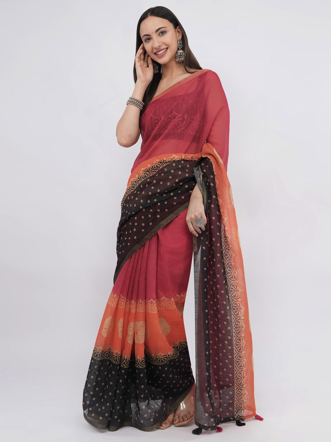 Beautiful woman styled in a classic off white linen saree featuring vibrant red and orange floral prints, a geometric border, and a matching unstitched blouse by Samantha.