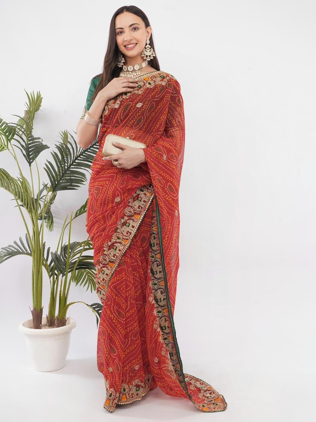 Beautiful woman styled in a classic deep red and gold geometric printed georgette saree featuring an abstract design and a matching unstitched blouse by Samantha.